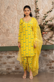 Woman wearing a yellow boho printed kurta set with dhoti pants and an organza dupatta in Senren's signature Bohemian print.
