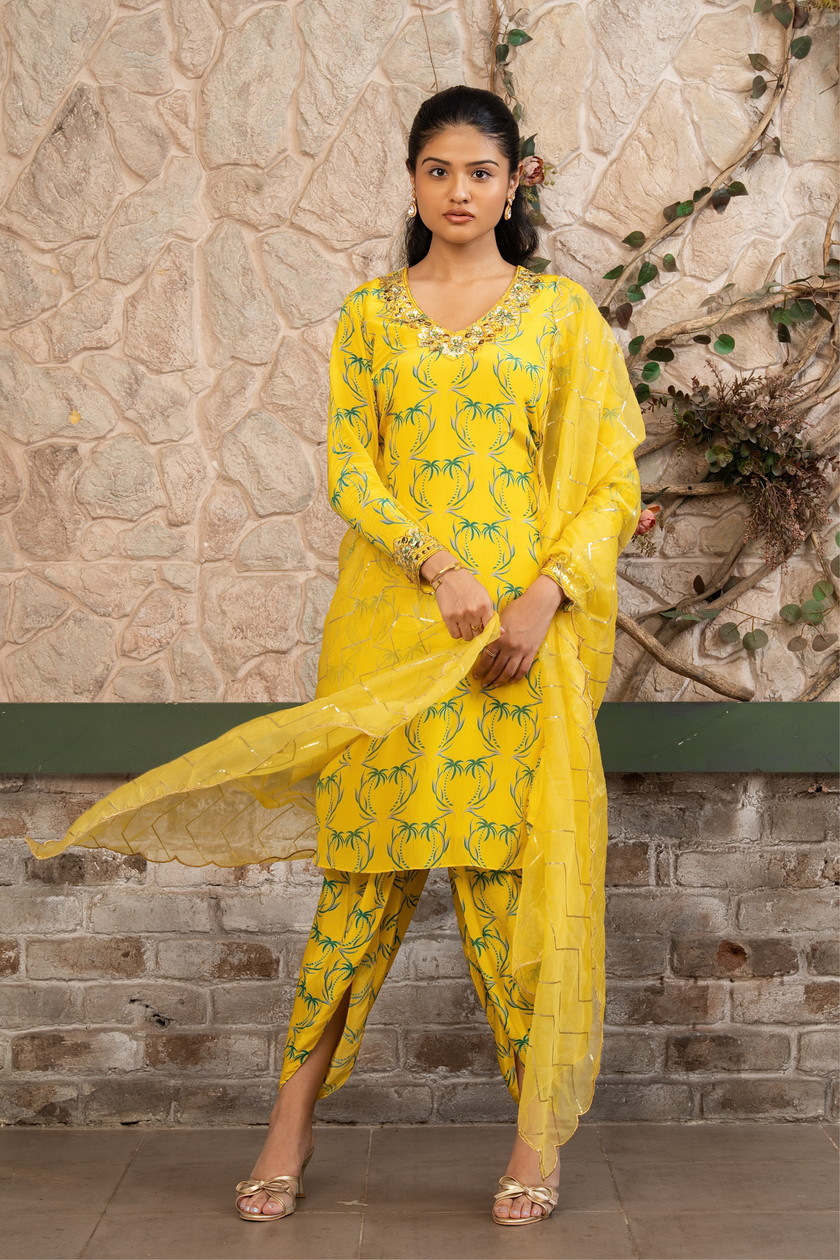 Woman wearing a yellow boho printed kurta set with dhoti pants and an organza dupatta in Senren's signature Bohemian print.