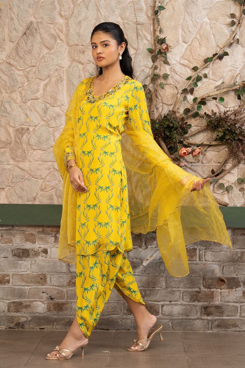 Woman wearing a yellow boho printed kurta set with dhoti pants and an organza dupatta in Senren's signature Bohemian print.
