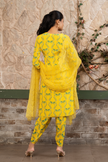 Woman wearing a yellow boho printed kurta set with dhoti pants and an organza dupatta in Senren's signature Bohemian print.