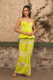 Woman wearing a lime green floral printed peplum top with a draped skirt co-ord set by Senren.