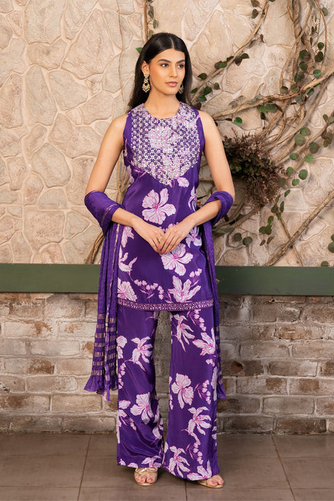Woman wearing a purple floral printed kurta set with a hand-embroidered yoke, wide-leg palazzo pants, and an embellished dupatta by Senren.