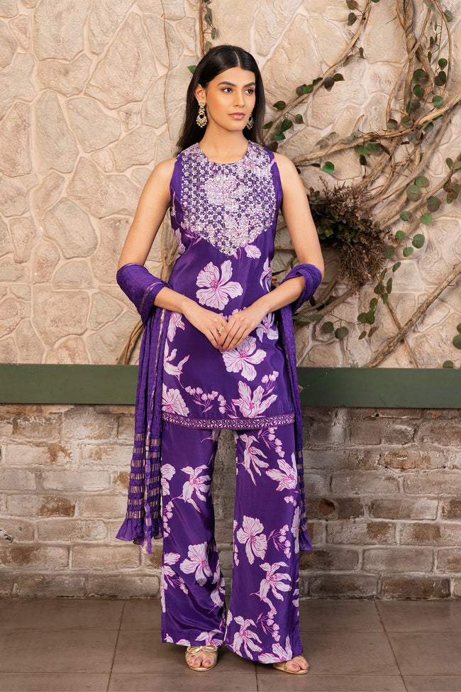 Woman wearing a purple floral printed kurta set with a hand-embroidered yoke, wide-leg palazzo pants, and an embellished dupatta by Senren.