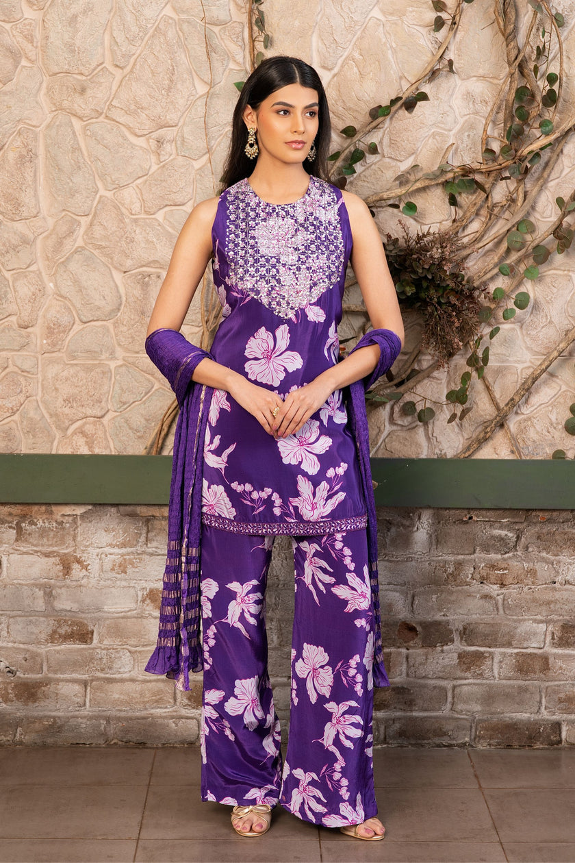 Woman wearing a purple floral printed kurta set with a hand-embroidered yoke, wide-leg palazzo pants, and an embellished dupatta by Senren.