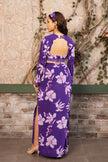 Woman wearing a violet floral printed crop top blouse with a matching high-waisted side slit skirt, luxury Indo-Western designer outfit by Senren.
