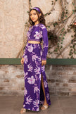 Woman wearing a violet floral printed crop top blouse with a matching high-waisted side slit skirt, luxury Indo-Western designer outfit by Senren.
