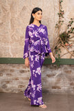 Woman wearing a violet floral printed pleated top with matching pants, luxury designer co-ord set for women by Senren.