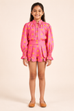 Pink printed top with structured tailored shorts.